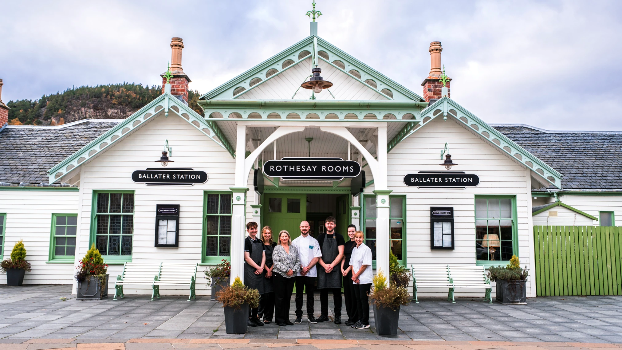 Staff standing in front of the Rothesay Rooms café